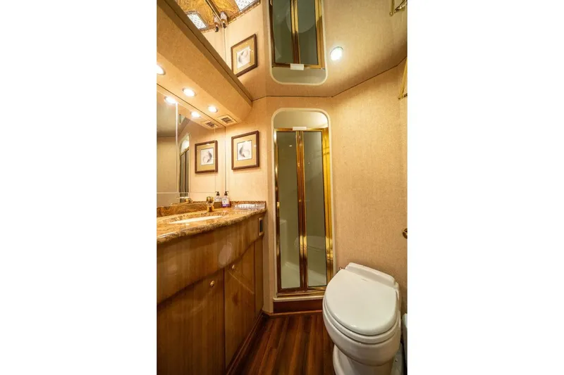 Slide: The Image of Luxurious bathroom in 2006 Viking 68 Convertible yacht with wood accents and modern fixtures. - 35