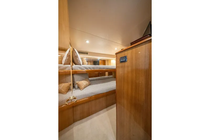 Slide: The Image of Interior of 2006 Viking 68 Convertible yacht with cozy bunk beds and wooden finish. - 36
