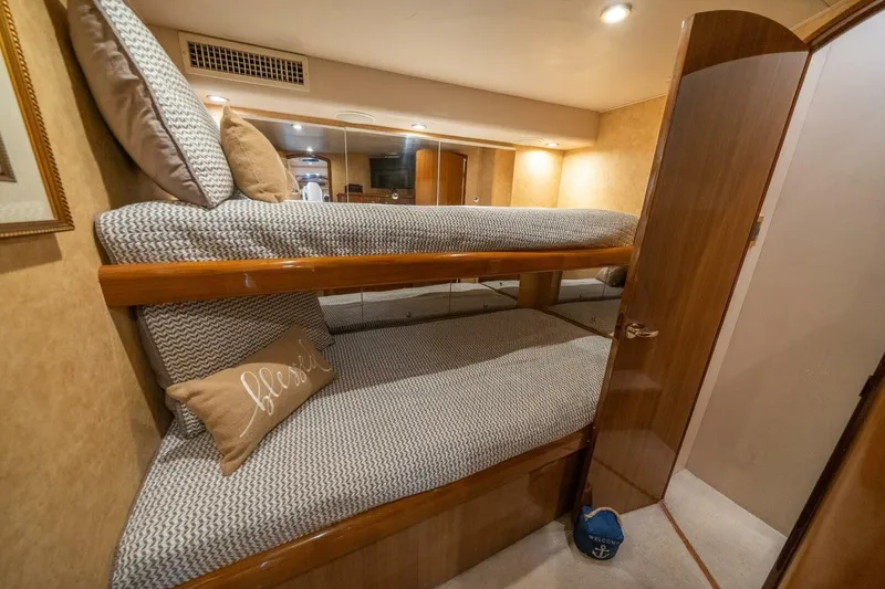 Slide: The Image of Interior of 2006 Viking 68 Convertible yacht with cozy bunk beds and elegant wood finish. - 38