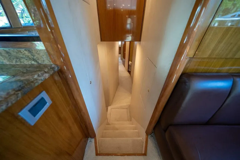Slide: The Image of Interior view of 2006 Viking 68 Convertible yacht, featuring a narrow carpeted staircase. - 40