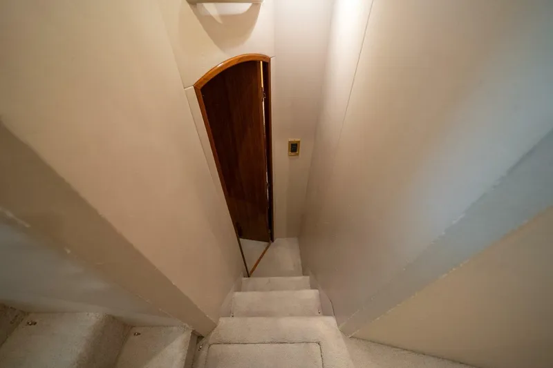 Slide: The Image of Staircase leading to a wooden door inside a 2006 Viking 68 Convertible yacht. - 41