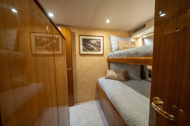 Slide: The Image of Luxurious cabin interior of 2006 Viking 68 Convertible yacht with cozy bunk beds. - 42