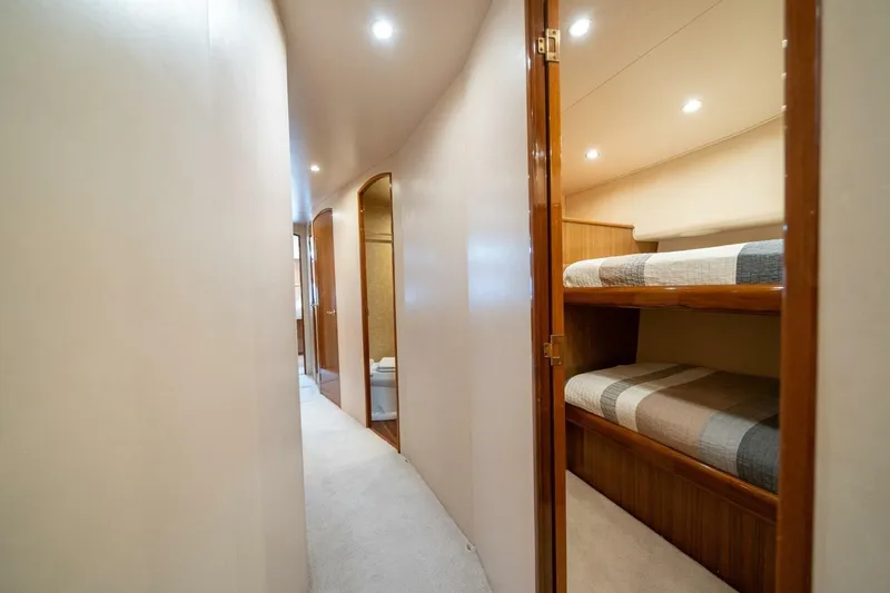 Slide: The Image of Interior hallway of 2006 Viking 68 Convertible yacht with bunk beds and modern lighting. - 43