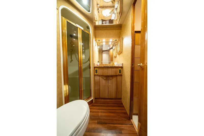 Slide: The Image of Luxurious bathroom interior of 2006 Viking 68 Convertible yacht with wood accents and glass shower. - 48