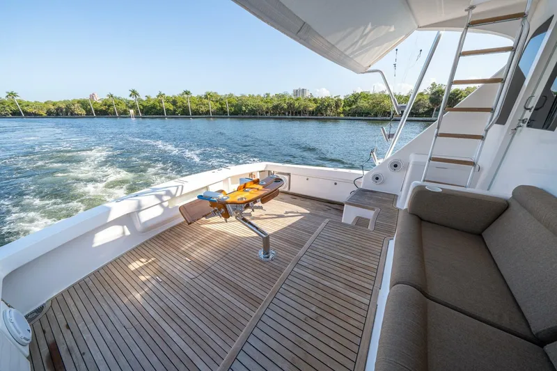 Slide: The Image of 2006 Viking 68 Convertible yacht deck with seating, table, and ocean view. - 51