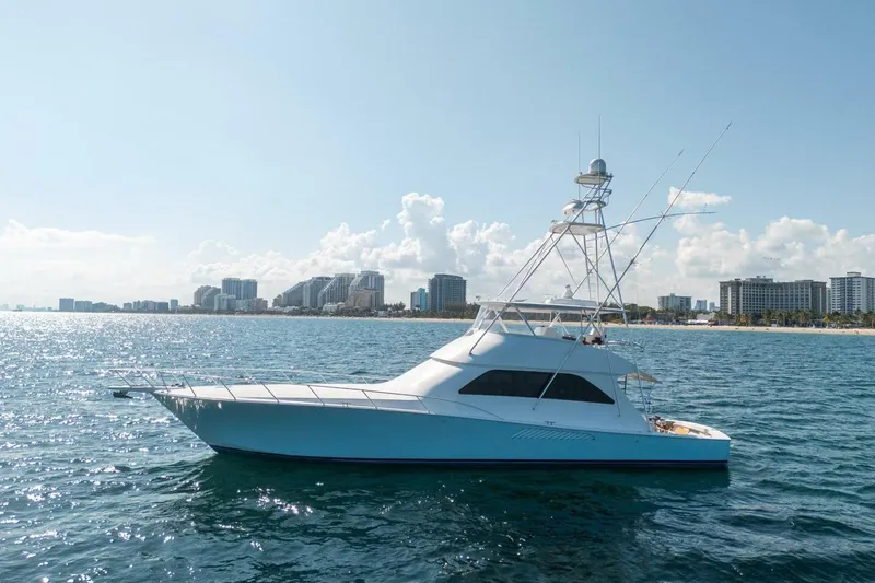 Slide: The Image of 2006 Viking 68 Convertible yacht cruising near a city skyline on a sunny day. - 8