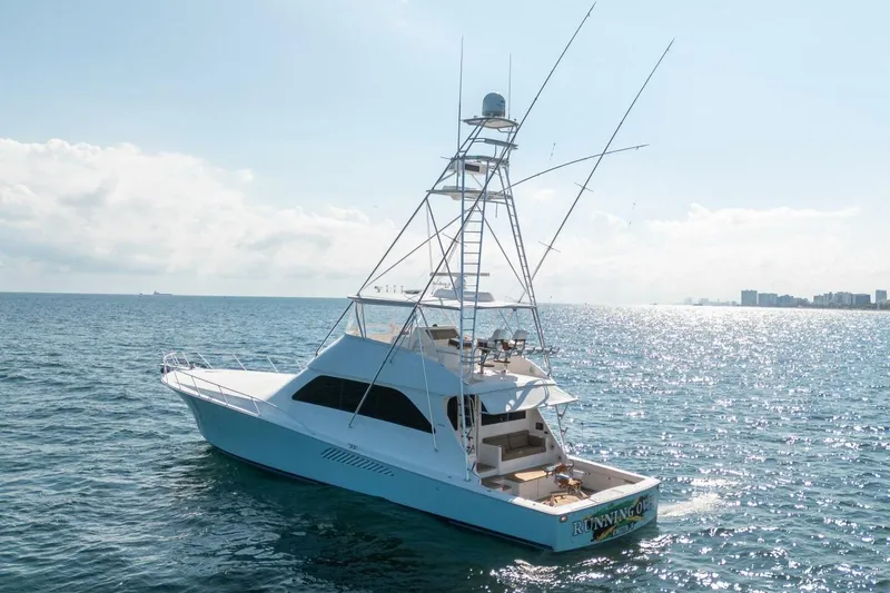 Slide: The Image of 2006 Viking 68 Convertible yacht on open sea under clear sky. - 9