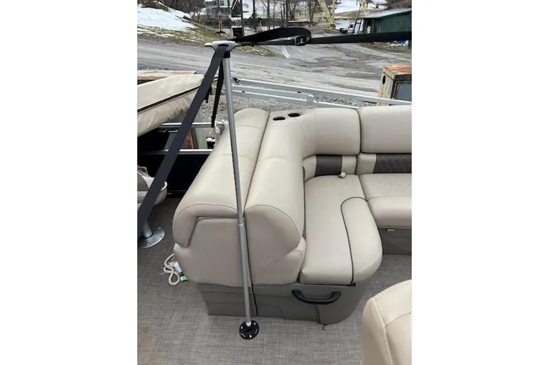 Slide: The Image of 2023 Sun Tracker Fishin' Barge 20 DLX with beige seating and cup holders. - 17