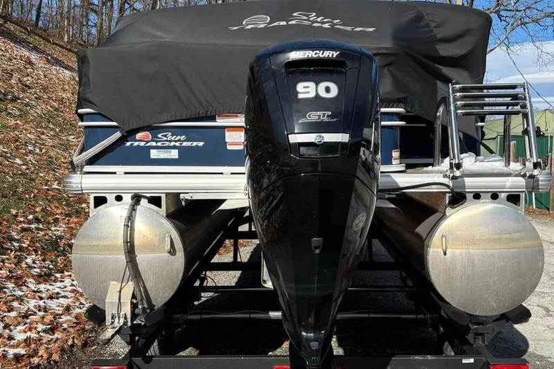 Slide: The Image of 2023 Sun Tracker Fishin' Barge 20 DLX with Mercury 90 engine on trailer. - 2