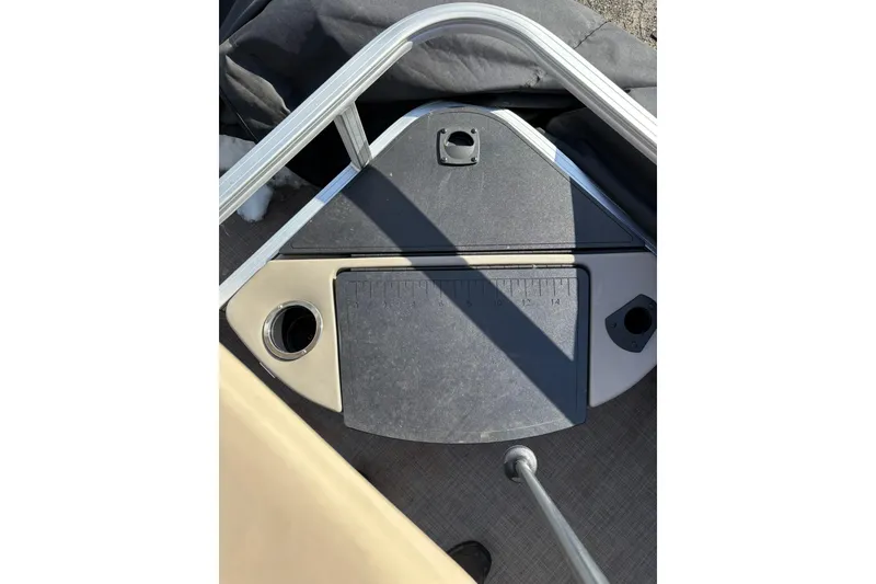 Slide: The Image of 2023 Sun Tracker Fishin' Barge 20 DLX deck with measuring board and cup holder. - 20