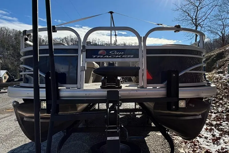 Slide: The Image of 2023 Sun Tracker Fishin' Barge 20 DLX on trailer under bright sun, winter landscape. - 3
