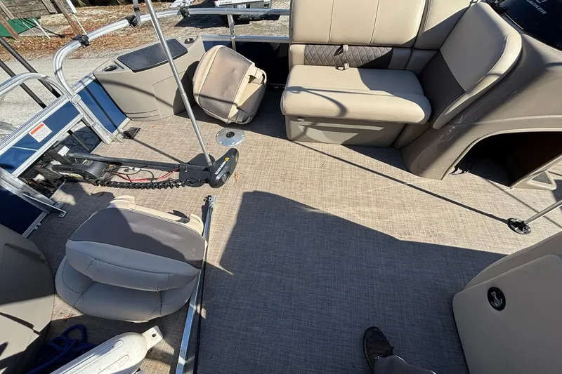 Slide: The Image of 2023 Sun Tracker Fishin' Barge 20 DLX interior with seating and fishing equipment. - 5