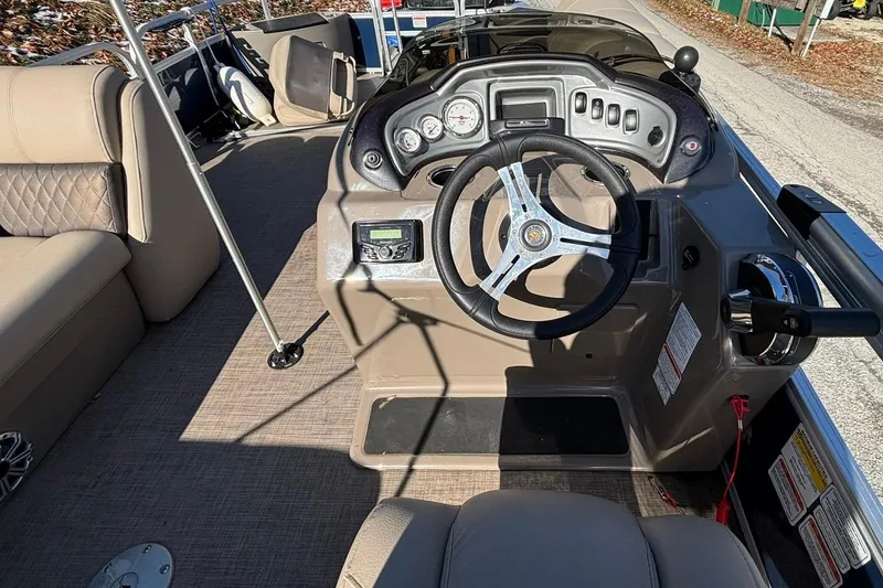 Slide: The Image of 2023 Sun Tracker Fishin' Barge 20 DLX interior with steering console and seating. - 6