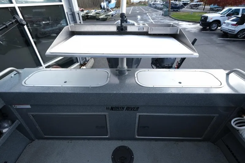 Slide: The Image of 2017 North River 21 SEAHAWK boat interior with storage compartments and cutting board. - 10