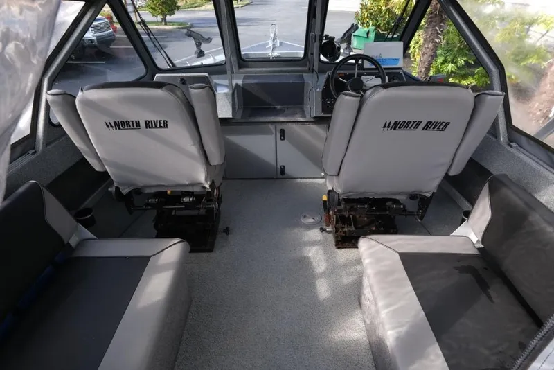 Slide: The Image of Interior of a 2017 North River 21 SEAHAWK boat with seating and steering console. - 11