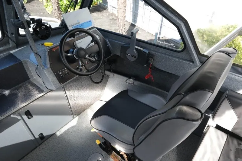 Slide: The Image of 2017 North River 21 SEAHAWK boat interior with steering wheel and seating. - 14
