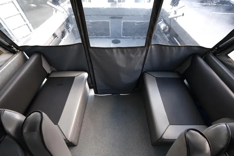 Slide: The Image of Interior of 2017 North River 21 SEAHAWK boat with cushioned seating and clear windows. - 19