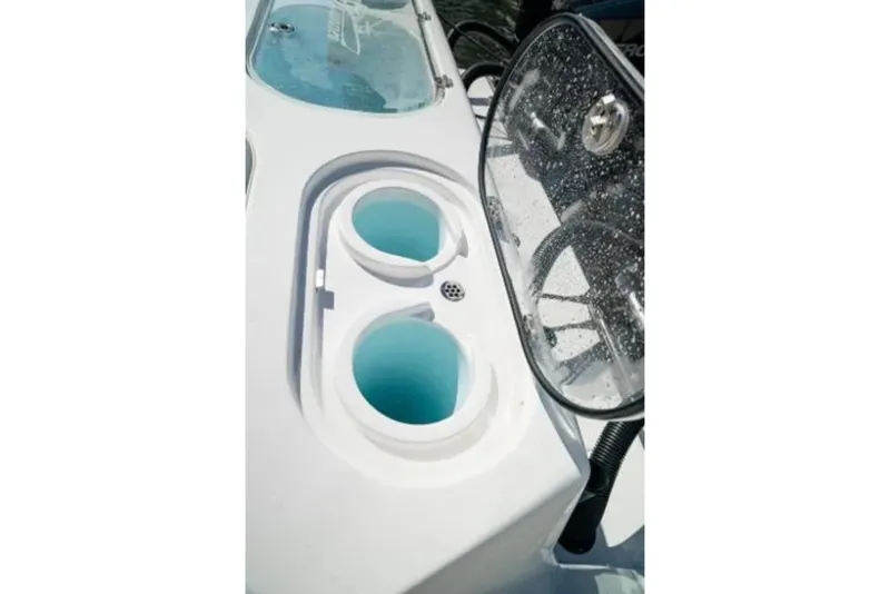 Slide: The Image of 2024 Front Runner 37 Catamaran's sleek deck with cup holders and windshield detail. - 101