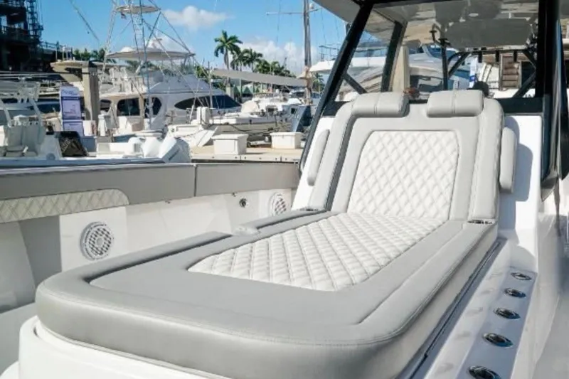 Slide: The Image of 2024 Front Runner 37 Catamaran cruising on water near a bridge and industrial port. - 17