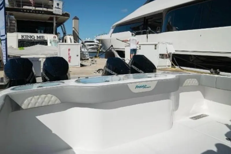 Slide: The Image of 2024 Front Runner 37 Catamaran cruising under a large suspension bridge on a sunny day. - 32