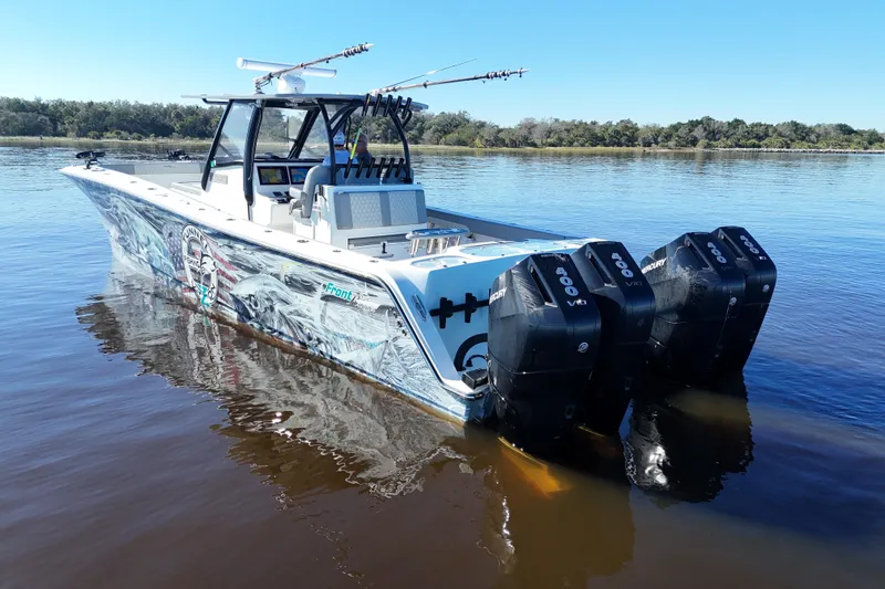 Slide: The Image of 2024 Front Runner 37 Catamaran with triple Mercury engines on calm water. - 41