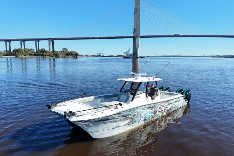 Slide: The Image of 2024 Front Runner 37 Catamaran on water near a large bridge. - 45
