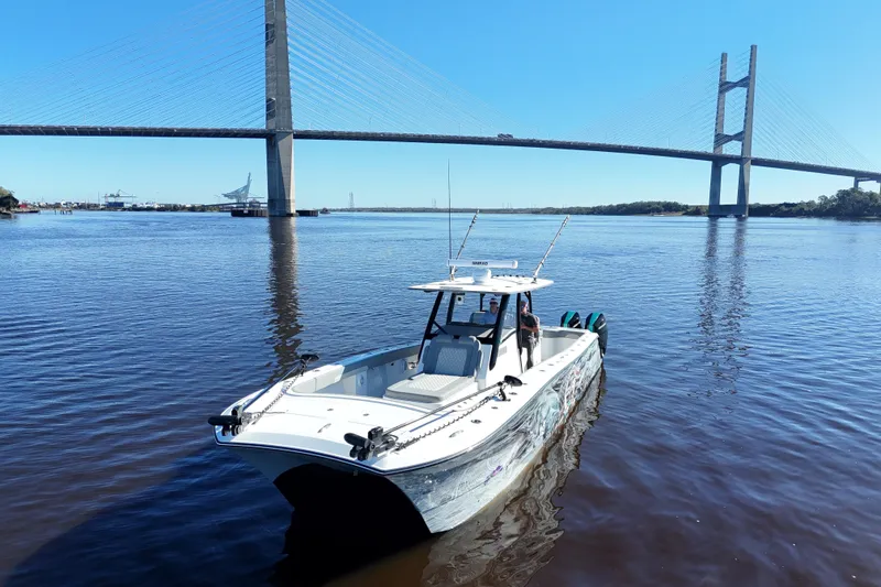 Slide: The Image of 2024 Front Runner 37 Catamaran on water near a large bridge. - 48