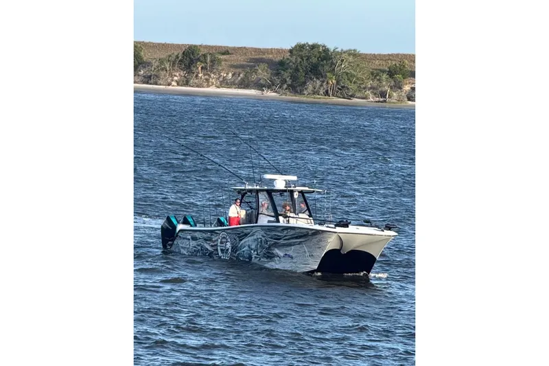 Slide: The Image of 2024 Front Runner 37 Catamaran cruising on water with vibrant fishing-themed graphics. - 5