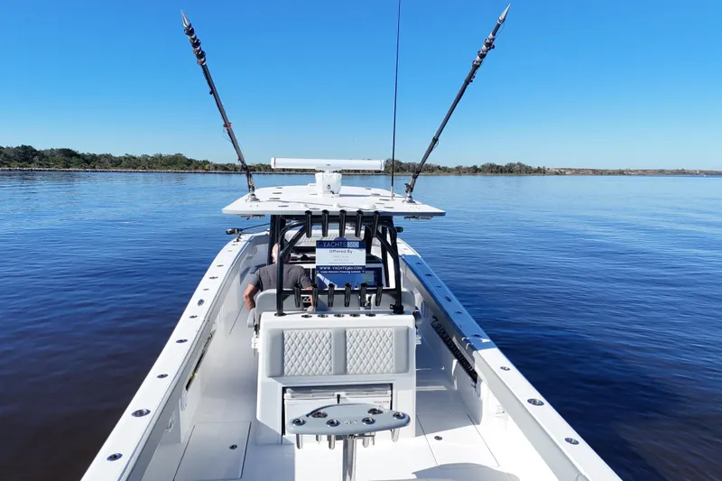 Slide: The Image of 2024 Front Runner 37 Catamaran on calm water, featuring fishing rods and spacious deck. - 51