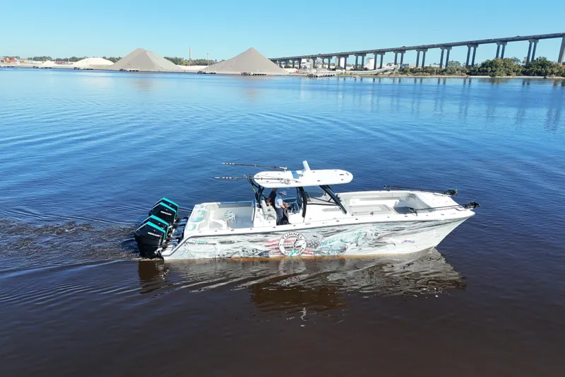 Slide: The Image of 2024 Front Runner 37 Catamaran cruising on calm waters near a bridge. - 54