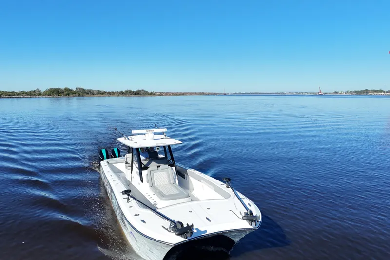 Slide: The Image of 2024 Front Runner 37 Catamaran cruising on a calm, blue waterway under clear skies. - 55