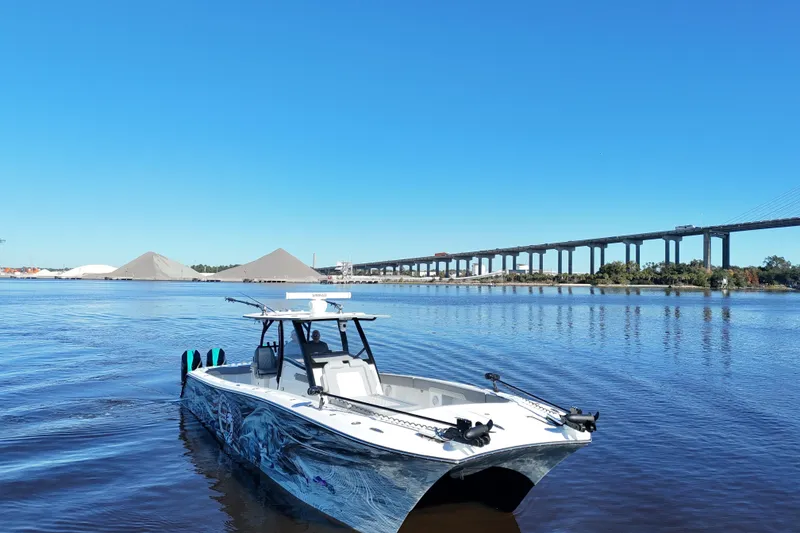 Slide: The Image of 2024 Front Runner 37 Catamaran on calm water with bridge and clear sky background. - 56