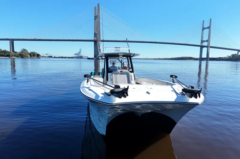 Slide: The Image of 2024 Front Runner 37 Catamaran on calm water near a large bridge. - 59