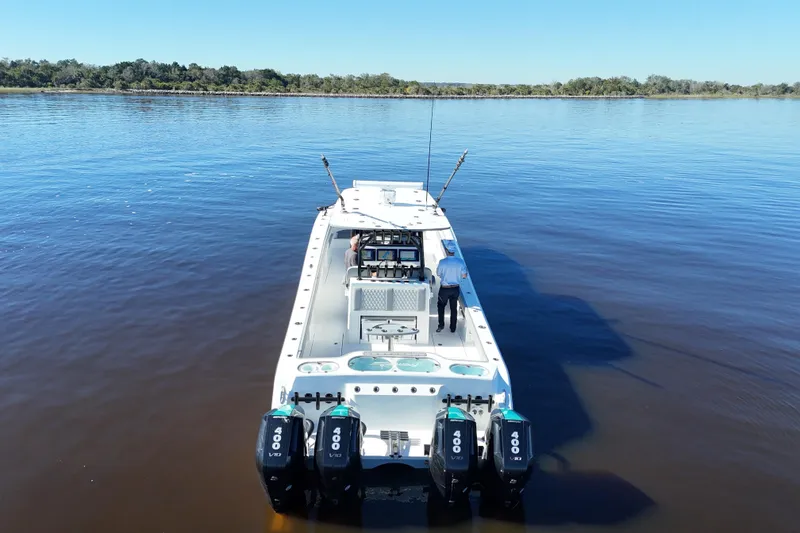 Slide: The Image of 2024 Front Runner 37 Catamaran on calm water, featuring four powerful outboard engines. - 61