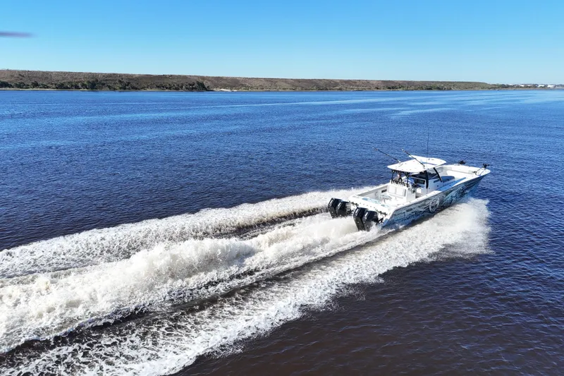 Slide: The Image of 2024 Front Runner 37 Catamaran cruising on open water under clear blue skies. - 64