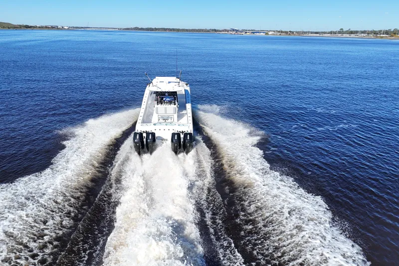 Slide: The Image of 2024 Front Runner 37 Catamaran cruising on open water, leaving a wake behind. - 66