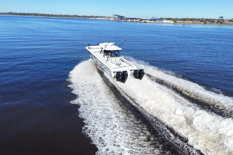 Slide: The Image of 2024 Front Runner 37 Catamaran cruising on open water, creating a dynamic wake. - 70