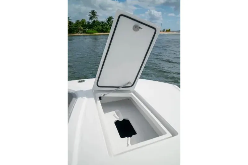 Slide: The Image of Open storage compartment on 2024 Front Runner 37 Catamaran, with ocean and island backdrop. - 76