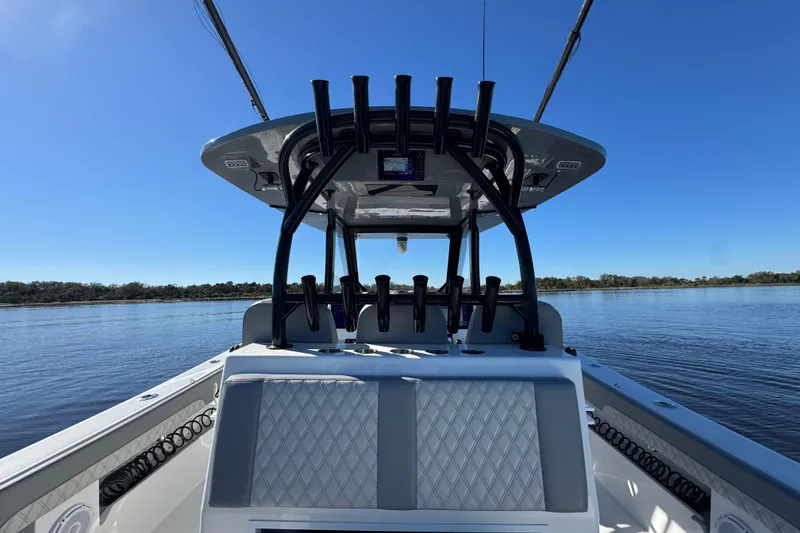 Slide: The Image of 2024 Front Runner 37 Catamaran on calm water, showcasing sleek design and spacious deck. - 90