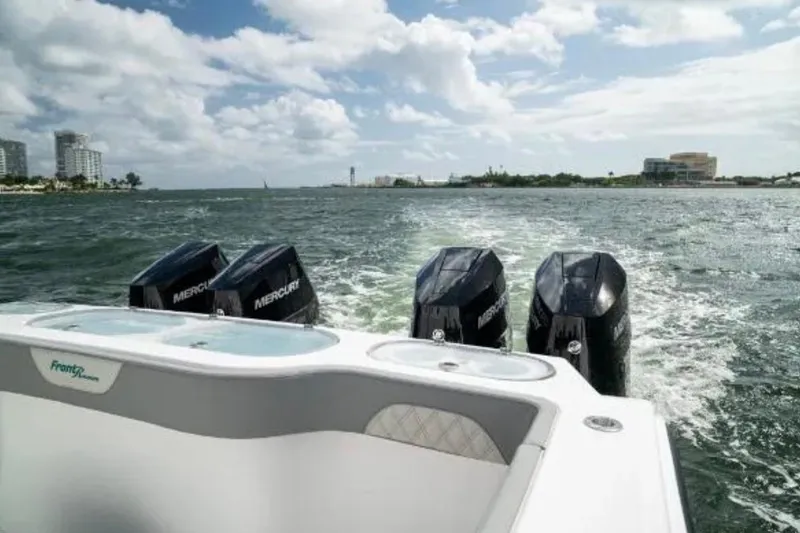 Slide: The Image of 2024 Front Runner 37 Catamaran with four Mercury engines cruising on open water. - 97