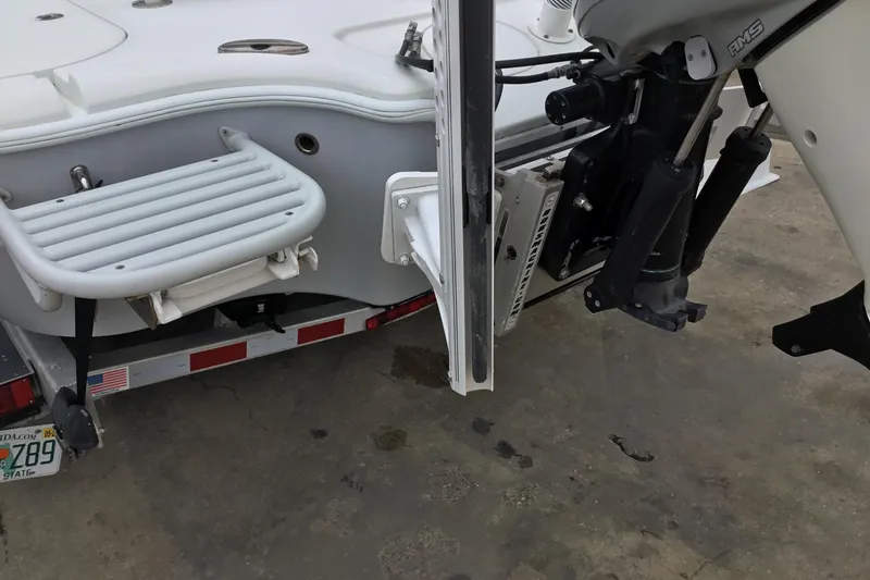 Slide: The Image of 2020 Yellowfin 24 Bay CE boat rear view with motor and swim platform. - 10