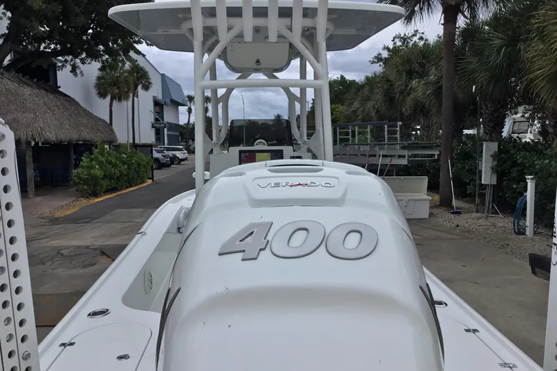Slide: The Image of 2020 Yellowfin 24 Bay CE boat with powerful 400 Verado engine, docked near palm trees. - 11