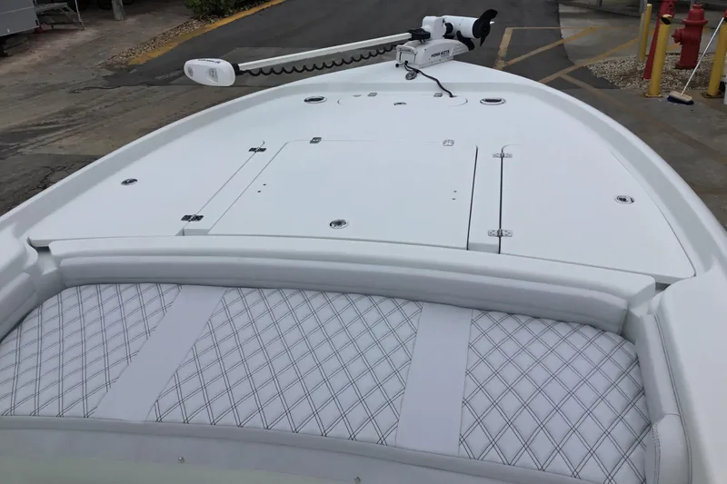 Slide: The Image of 2020 Yellowfin 24 Bay CE boat deck with diamond-stitched seating and trolling motor. - 12