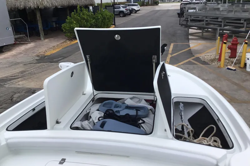 Slide: The Image of 2020 Yellowfin 24 Bay CE boat storage compartments open, showing ropes and equipment. - 13