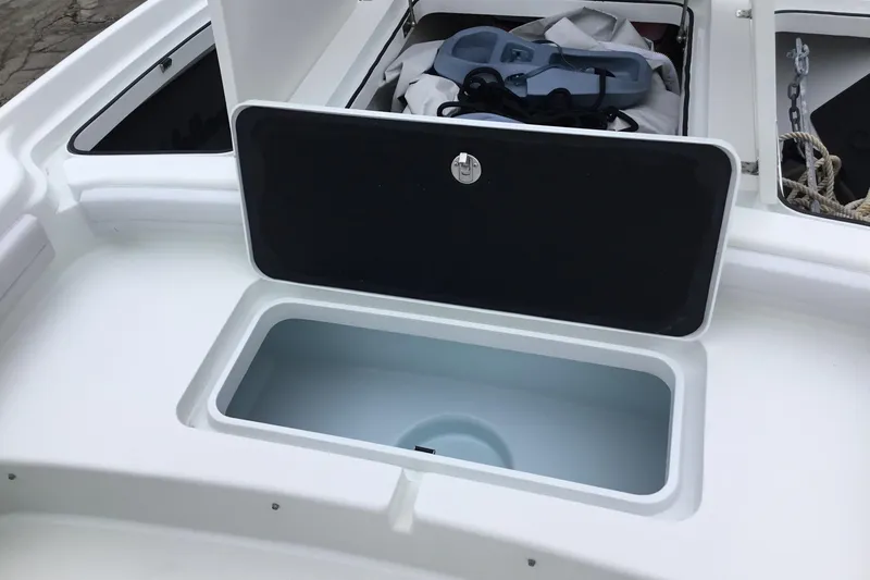 Slide: The Image of 2020 Yellowfin 24 Bay CE boat storage compartment with open hatch, showcasing interior space. - 14