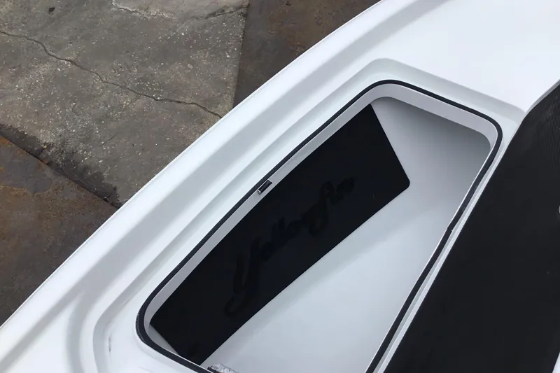 Slide: The Image of 2020 Yellowfin 24 Bay CE boat storage compartment with logo detail. - 15