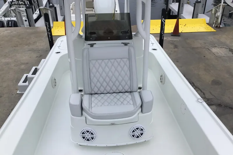 Slide: The Image of 2020 Yellowfin 24 Bay CE boat interior with cushioned seating and speakers. - 19