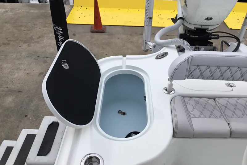 Slide: The Image of 2020 Yellowfin 24 Bay CE boat interior with open storage compartment and seating. - 22
