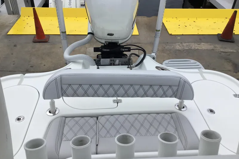 Slide: The Image of 2020 Yellowfin 24 Bay CE boat interior with diamond-stitched seating and rod holders. - 27