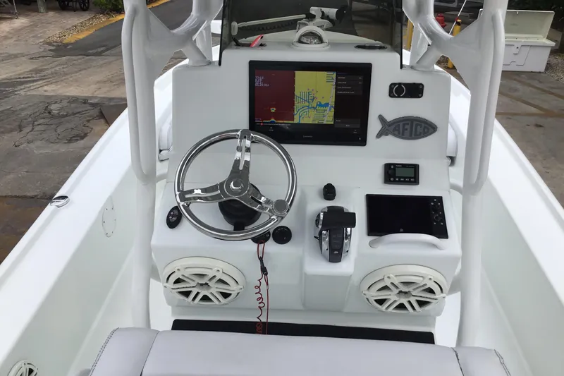 Slide: The Image of 2020 Yellowfin 24 Bay CE boat dashboard with steering wheel and navigation display. - 28